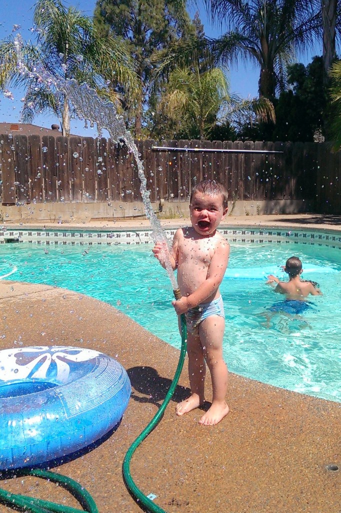 Water fun with the hose next to the pool during a hot Fresno summer afternoon! - Melissa