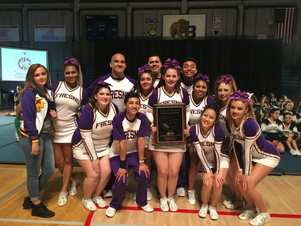 Fresno High's cheer squad holding plaque