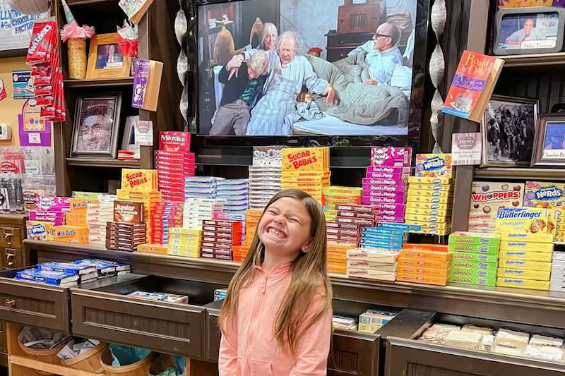 Smiling Kid in front of the movie at Abigail’s Candy Shop in Clovis