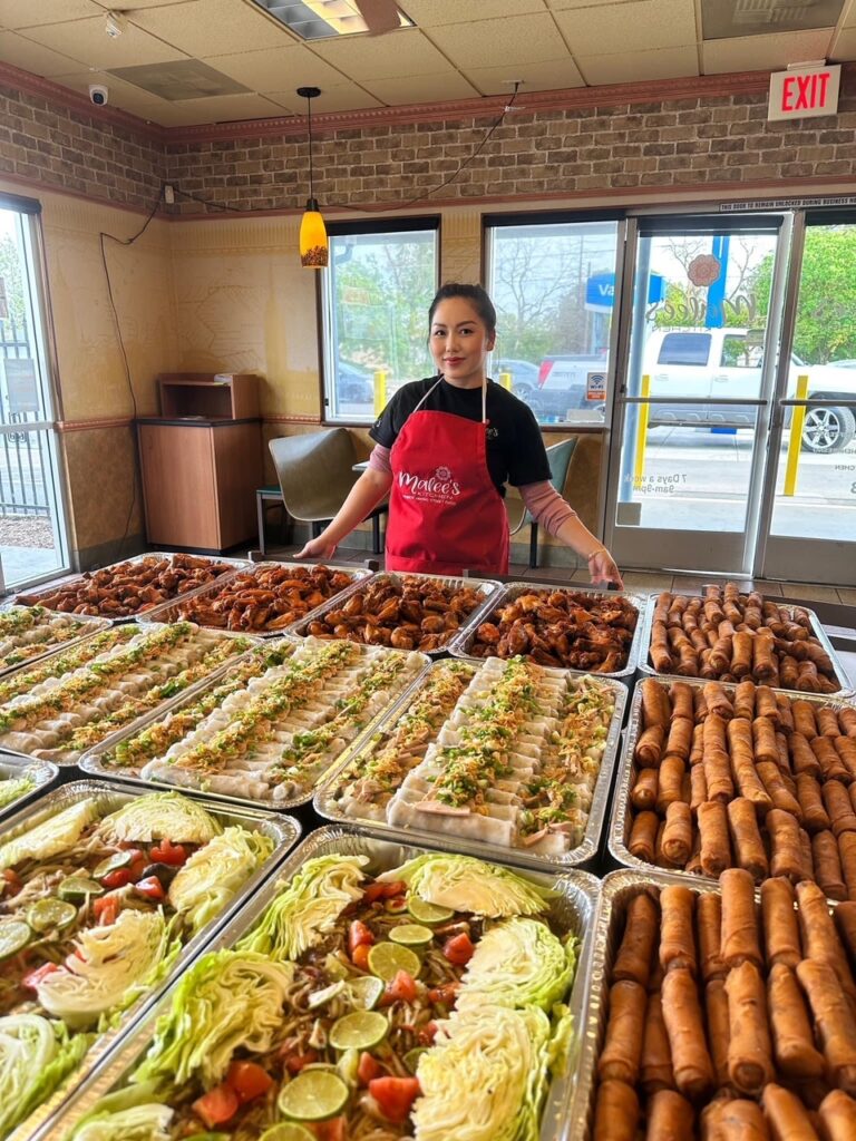 Malee Vang, owner of Malee's Kitchen, shown with trays and trays of her amazing Hmong street-style cuisine (my organization and our guests were the lucky recipients of this order!)